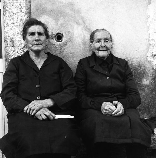 Deux dames, habillées en noir, assises dans un village du nord-ouest du Portugal . 1994.