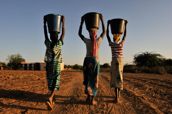 Des femmes portent de l'eau potable sur la tête. Mali. Pays Dogon. 2009